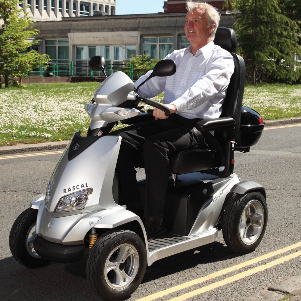 Person driving the Merits Silverado Extreme mobility scooter on a long and flat road