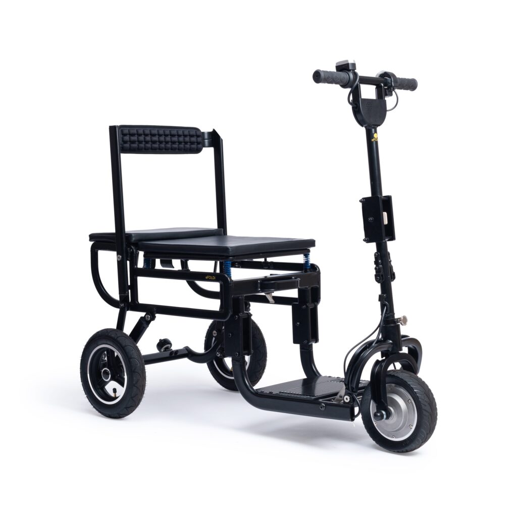 eFOLDi Lite Foldable Lightweight Mobility Scooter in black, showcasing its fully unfolded state ready for use with a padded seat, adjustable handlebar, and sturdy wheels. The mobility scooter combines portability and comfort for users with mobility needs, highlighting the practical design suitable for urban environments.